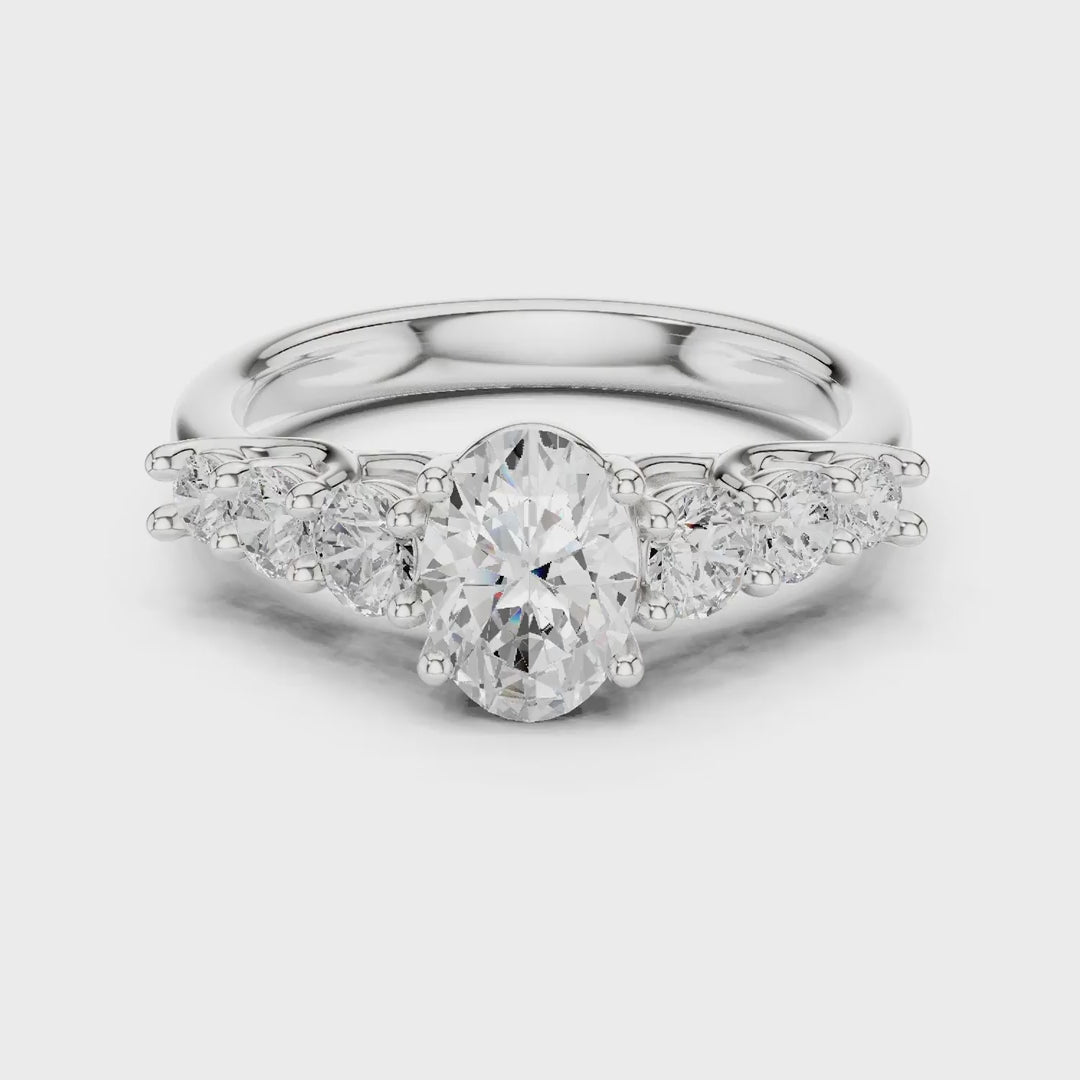 MJR070 - Oval Cut Round Flanked Graduated Accent Ring