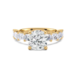 Round diamond ring with side emerald diamonds